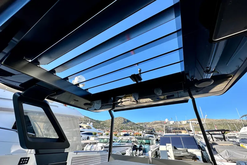  Yacht Photos Pics Interior view of 2022 Cranchi A46 Luxury Tender with open sunroof at marina.
