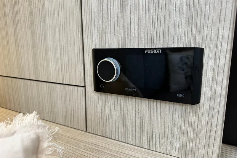  Yacht Photos Pics Fusion audio system on 2022 Cranchi A46 Luxury Tender, mounted on wood panel.