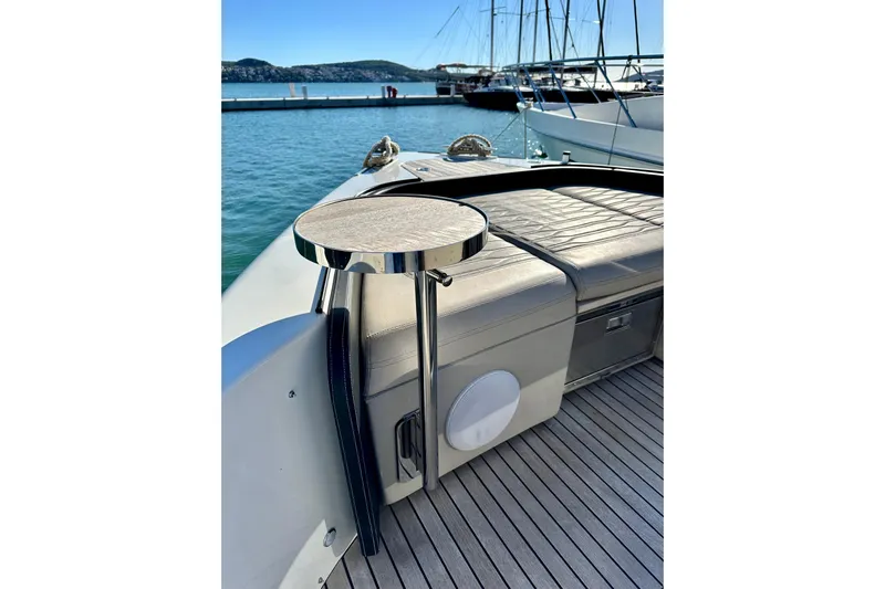  Yacht Photos Pics Cranchi A46 Luxury Tender 2022, elegant deck seating with table, docked in marina.