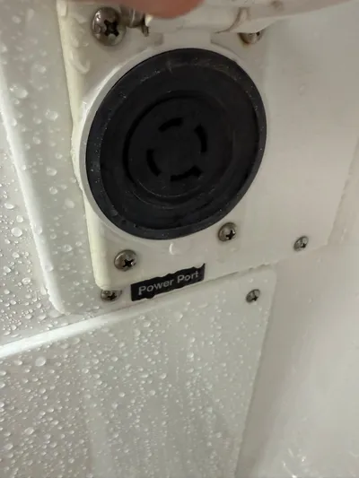  Yacht Photos Pics Power port on 2023 Everglades 285 Center Console, wet surface, close-up view.