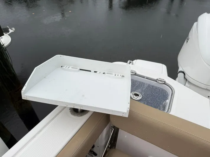  Yacht Photos Pics 2023 Everglades 285 Center Console boat with a white accessory tray and beige seating.