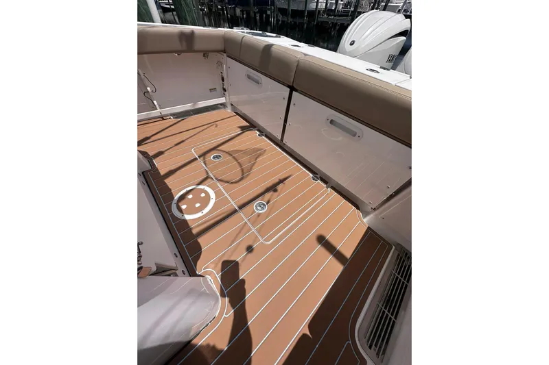  Yacht Photos Pics 2023 Everglades 285 Center Console boat deck with tan seating and wood-style flooring.