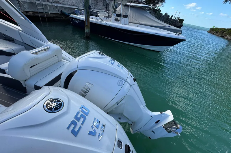  Yacht Photos Pics 2024 Regal LX9 boat with Yamaha 250 V6 engines docked in clear water.