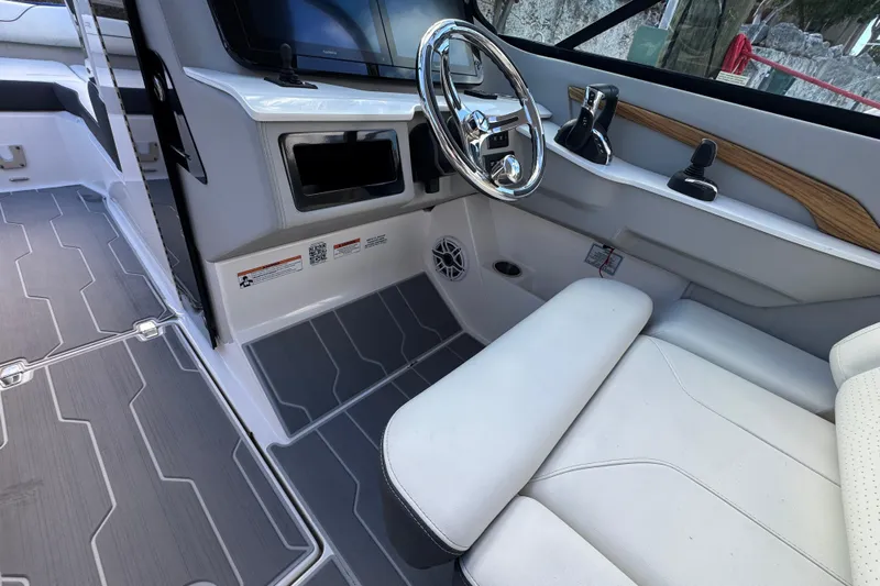  Yacht Photos Pics 2024 Regal LX9 boat interior with steering wheel and modern controls.