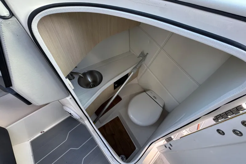  Yacht Photos Pics 2024 Regal LX9 boat interior bathroom with compact sink and toilet.