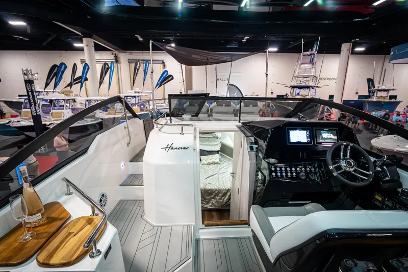  Yacht Photos Pics Interior view of 2026 Hanover 347 boat at a showroom, featuring modern cockpit and cabin.