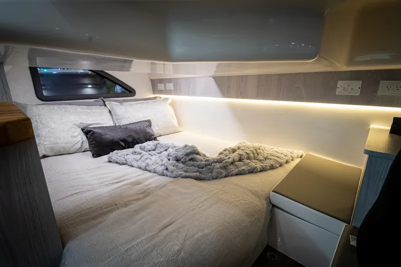  Yacht Photos Pics Luxurious interior of 2026 Hanover 347 camper with cozy bed and ambient lighting.