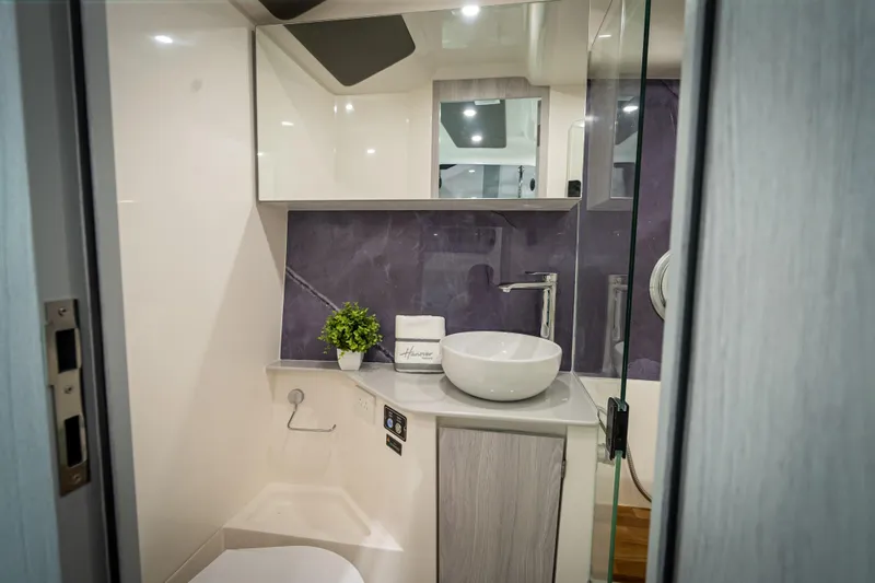  Yacht Photos Pics Modern bathroom in 2026 Hanover 347 RV with sleek design and vessel sink.