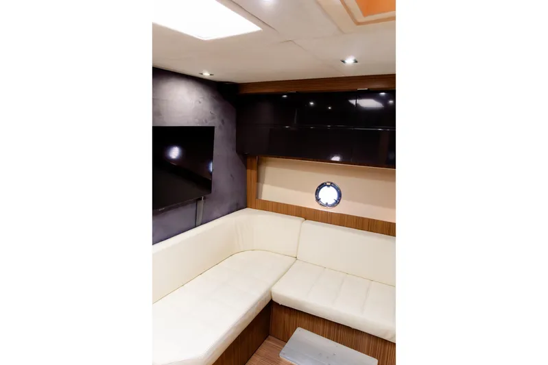  Yacht Photos Pics Luxurious interior of 2013 Azimut Atlantis 48 yacht with modern seating and porthole.