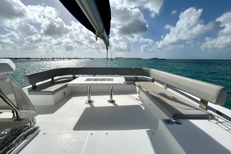  Yacht Photos Pics Leopard 50 yacht deck with seating, ocean view, and cloudy sky, 2020 model.