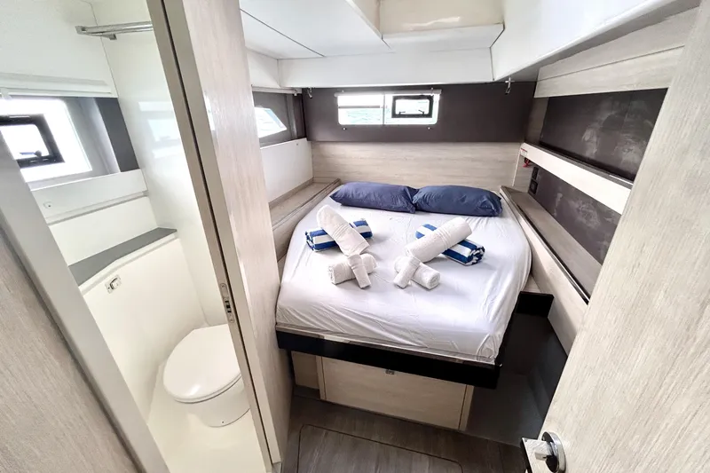  Yacht Photos Pics Luxurious cabin interior of 2020 Leopard 50 yacht with neatly arranged bed and towels.