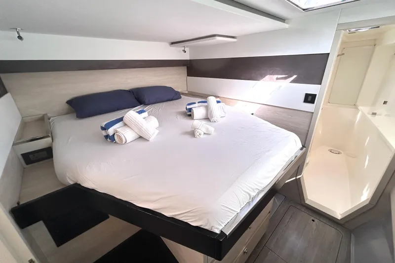  Yacht Photos Pics Luxurious bedroom in 2020 Leopard 50 yacht with neatly arranged towels and modern decor.