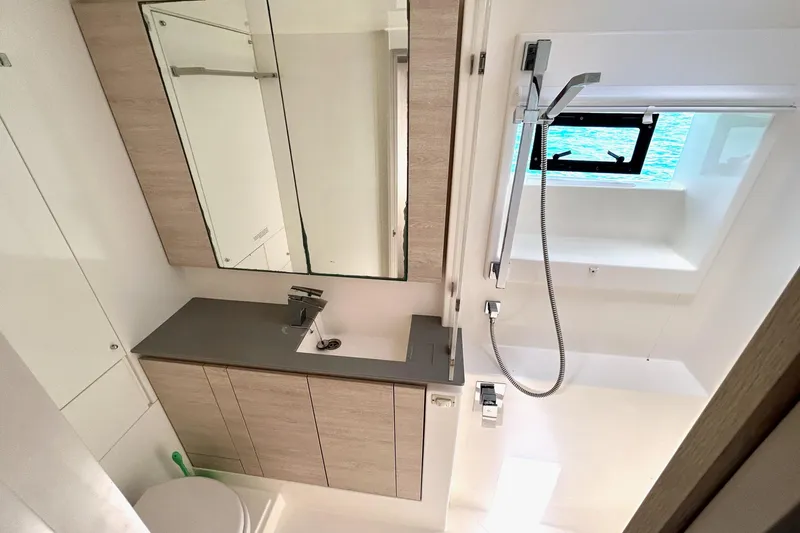  Yacht Photos Pics Modern bathroom interior on a 2020 Leopard 50 yacht, featuring sleek fixtures and a window view.