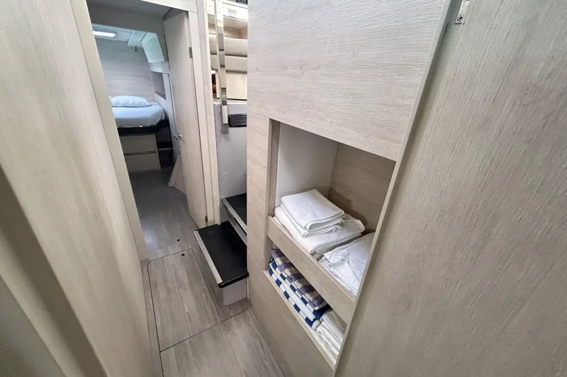  Yacht Photos Pics Modern Leopard 50 yacht interior with hallway, storage shelves, and cozy bedroom, 2020 model.