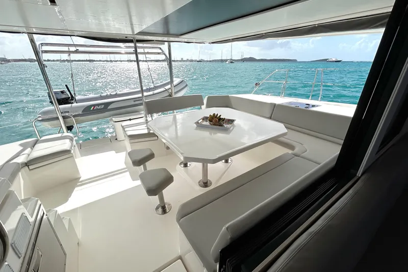  Yacht Photos Pics Luxurious 2020 Leopard 50 yacht interior with dining area overlooking turquoise sea.
