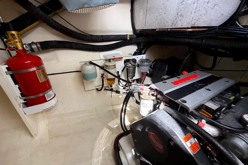 Yacht Photos Pics Engine room of a 2020 Leopard 50 yacht with fire extinguisher and mechanical components.