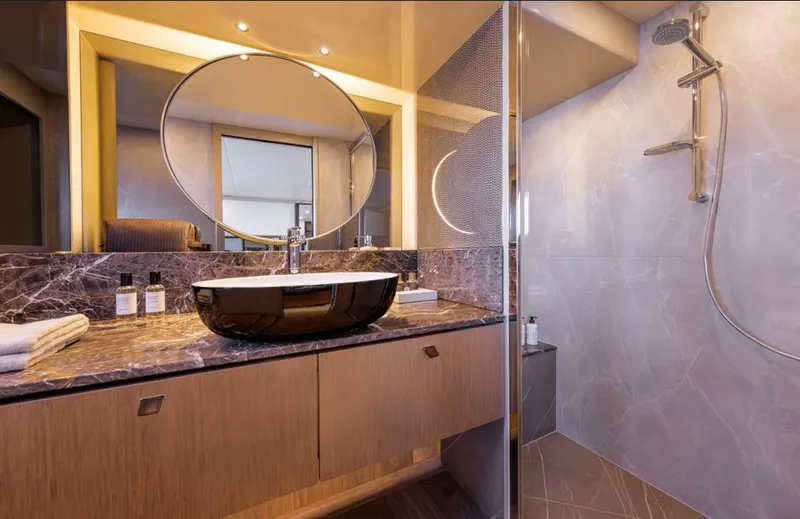 Absolute 60 Fly Yacht Photos Pics Luxurious bathroom in 2025 Absolute 60 Fly yacht with modern sink and shower.