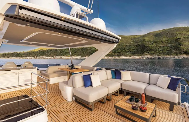Absolute 60 Fly Yacht Photos Pics Luxurious 2025 Absolute 60 Fly yacht with spacious deck and elegant seating, set against scenic coastline.