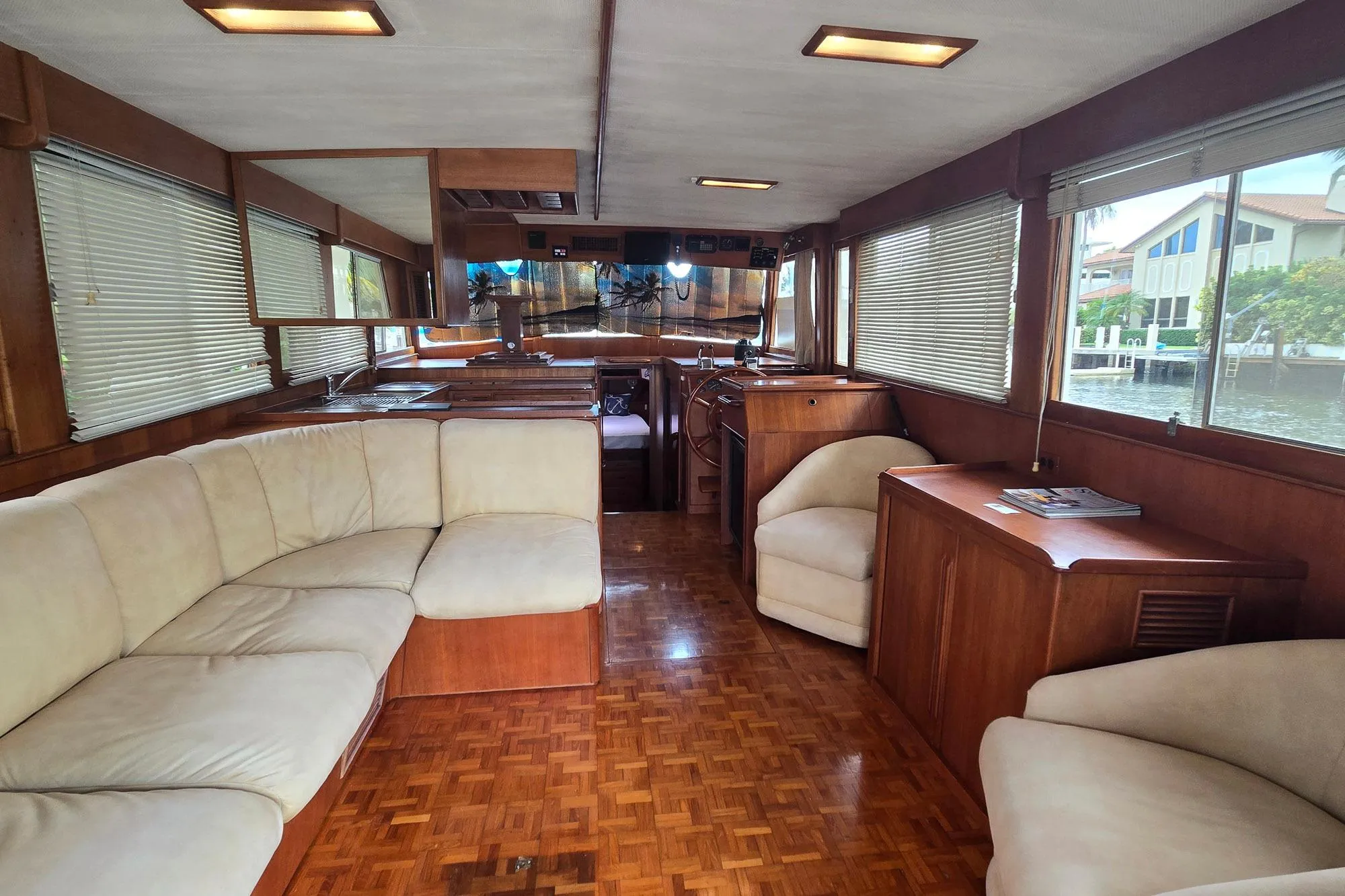 Luxurious interior of 1997 Grand Banks 46 Europa yacht with elegant wood finish and plush seating.