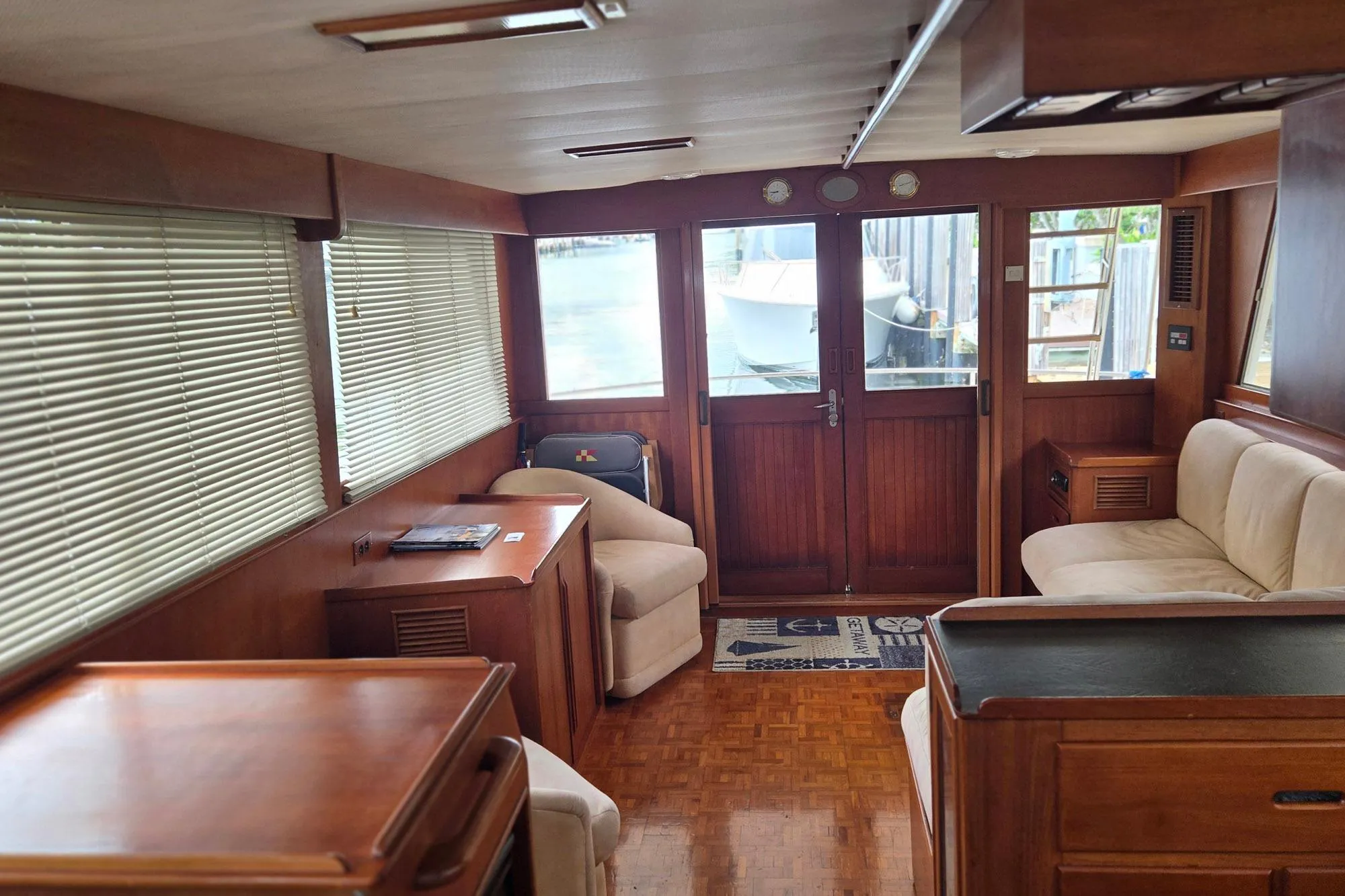 Interior of 1997 Grand Banks 46 Europa yacht with wooden furnishings and comfortable seating.