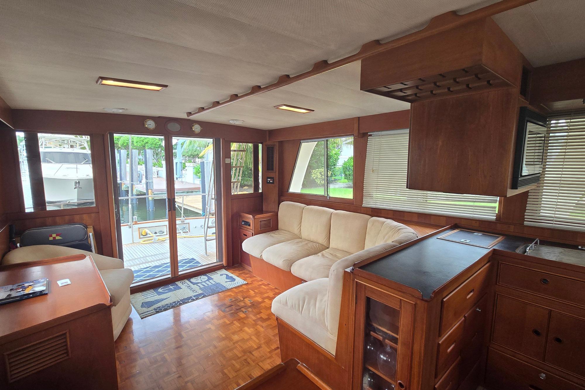 Interior of 1997 Grand Banks 46 Europa yacht with wood finish and comfortable seating.