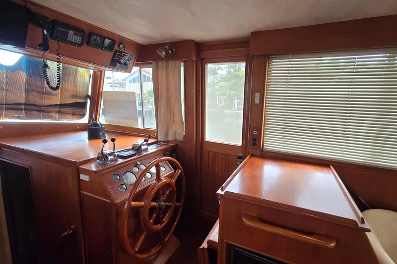 Safari Yacht Photos Pics Interior helm of 1997 Grand Banks 46 Europa yacht with wooden steering wheel and controls.