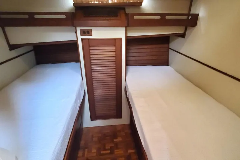 Safari Yacht Photos Pics 1997 Grand Banks 46 Europa cabin with twin beds and wooden interior.