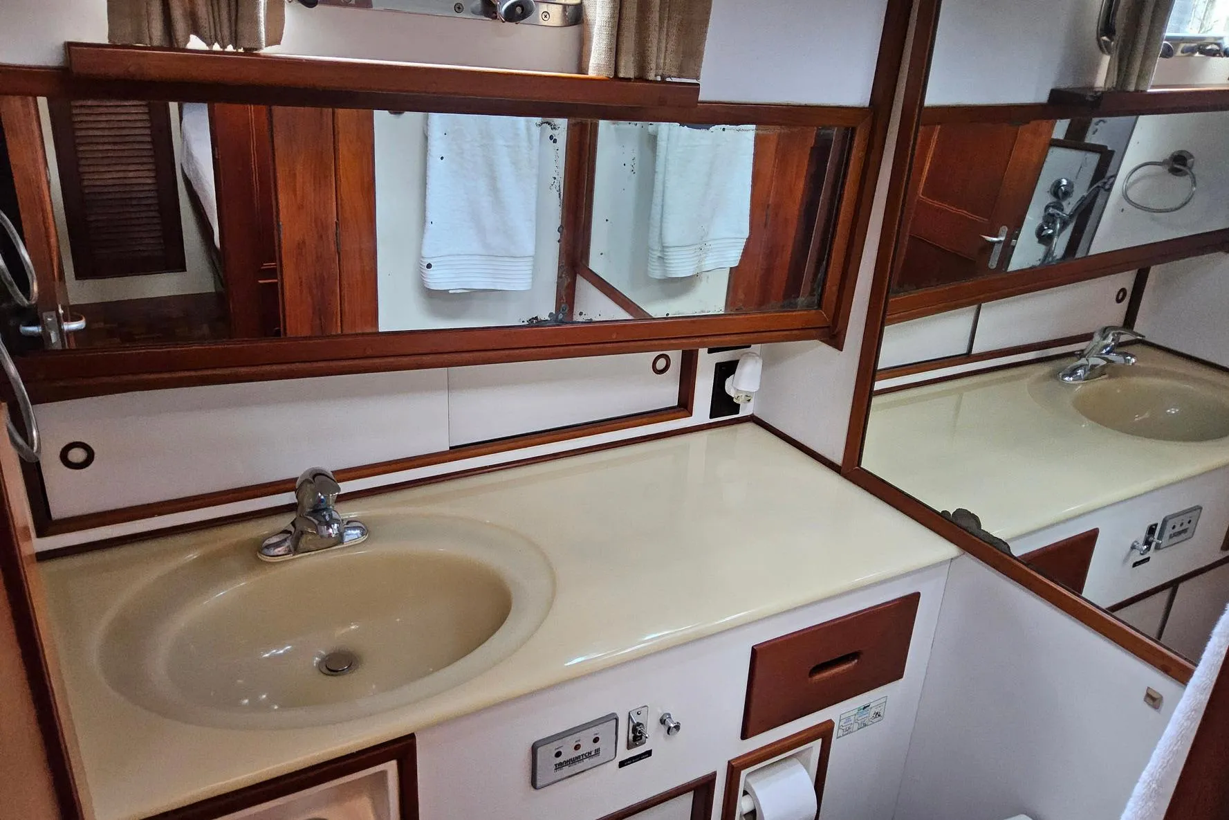 Bathroom interior of 1997 Grand Banks 46 Europa yacht with sink and mirror.