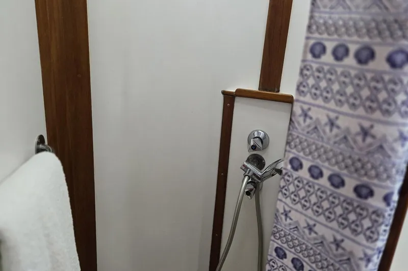 Safari Yacht Photos Pics Shower area in 1997 Grand Banks 46 Europa yacht with patterned curtain and towel.