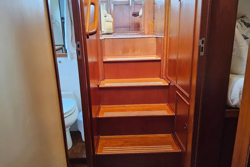 Safari Yacht Photos Pics Interior stairs of 1997 Grand Banks 46 Europa yacht with wooden finish.
