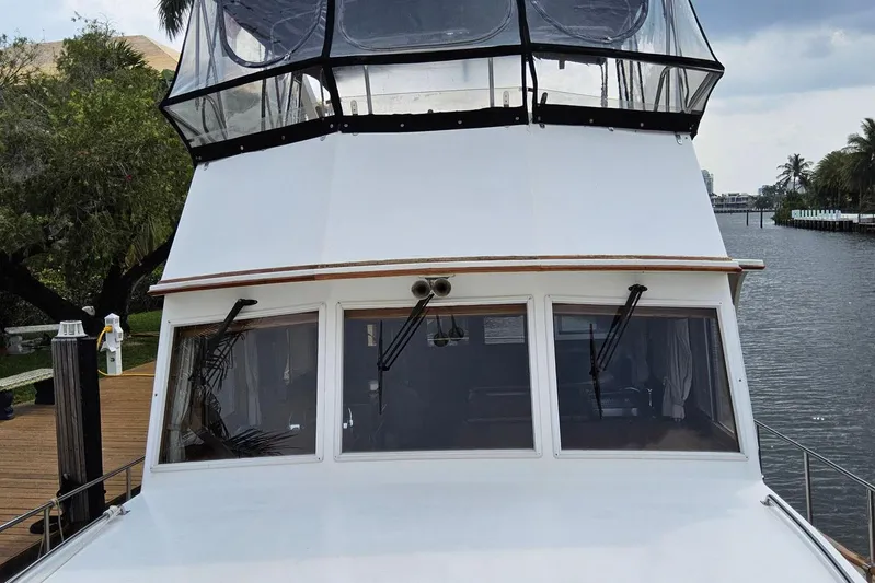 Safari Yacht Photos Pics 1997 Grand Banks 46 Europa yacht docked by a serene waterfront.