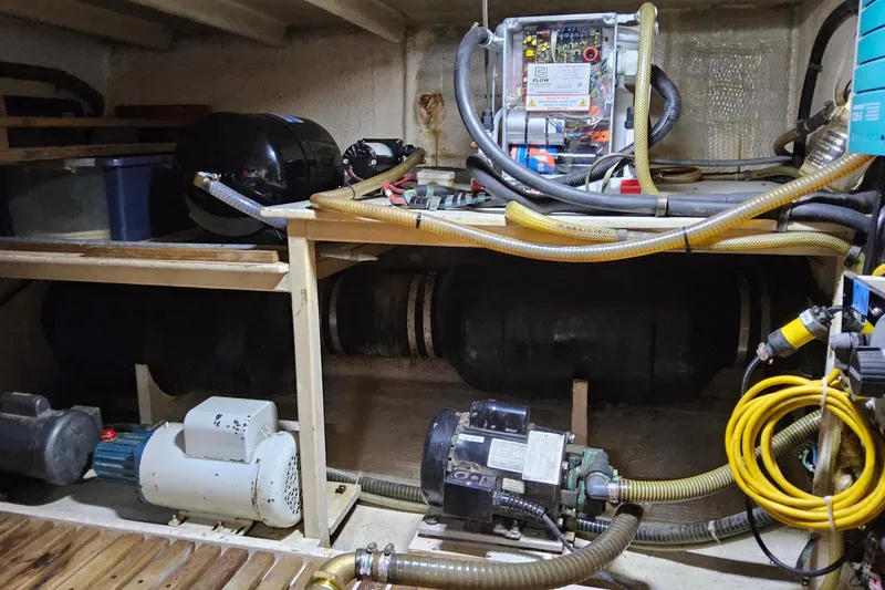 Safari Yacht Photos Pics Engine room of a 1997 Grand Banks 46 Europa with various mechanical components and hoses.