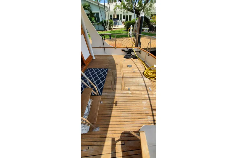 Safari Yacht Photos Pics Teak deck of 1997 Grand Banks 46 Europa yacht with outdoor seating and coiled hose.