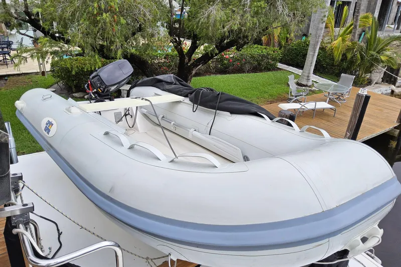 Safari Yacht Photos Pics Inflatable boat on Grand Banks 46 Europa, 1997, docked near lush garden and patio.