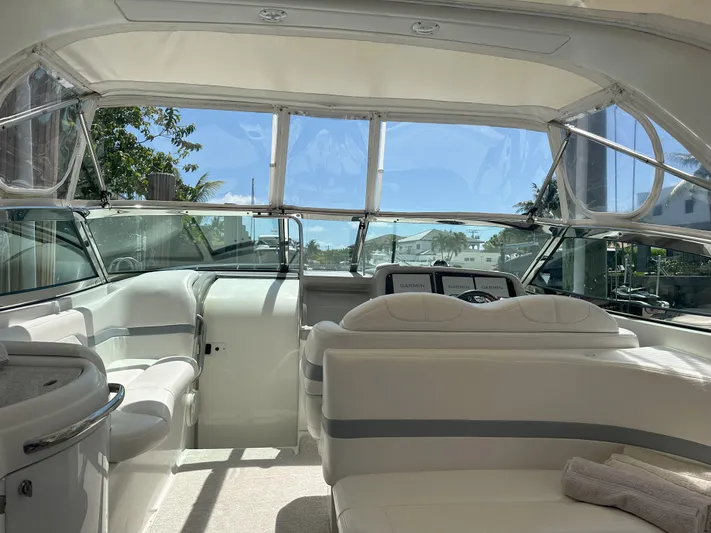  Yacht Photos Pics Interior of a 2004 Formula 330 SS boat with white seating and clear windows.