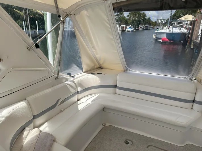  Yacht Photos Pics Interior of a 2004 Formula 330 SS boat with white seating and waterfront view.