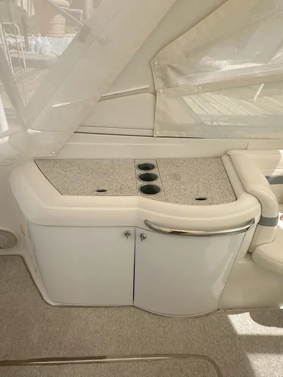  Yacht Photos Pics Interior view of a 2004 Formula 330 SS boat with cup holders and storage.