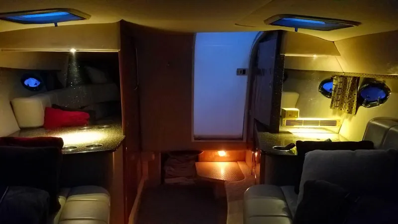  Yacht Photos Pics Interior cabin of a 2004 Formula 330 SS boat, dimly lit with cozy seating.