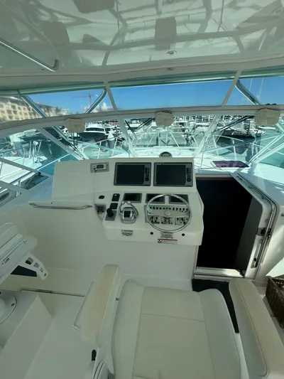 Cayuco Yacht Photos Pics 2010 Cabo 40 Express yacht helm with dual screens and steering wheel.