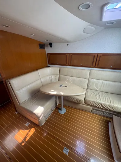 Cayuco Yacht Photos Pics 2010 Cabo 40 Express yacht interior with leather seating and wooden flooring.