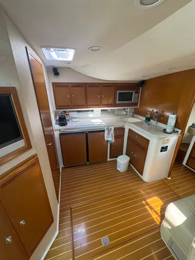 Cayuco Yacht Photos Pics 2010 Cabo 40 Express yacht interior with modern kitchen and wooden flooring.