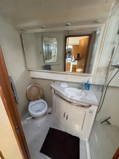 Cayuco Yacht Photos Pics 2010 Cabo 40 Express yacht bathroom with sink, toilet, and mirror.