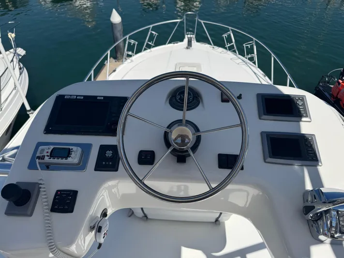 Cayuco Yacht Photos Pics Helm of 2010 Cabo 40 Express yacht with steering wheel and navigation controls.