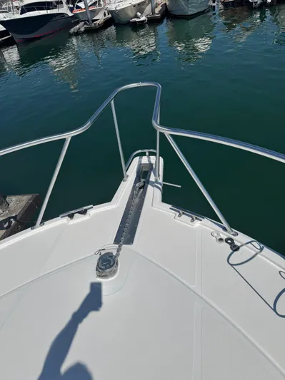 Cayuco Yacht Photos Pics Bow of 2010 Cabo 40 Express boat docked in marina.