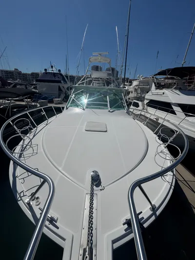 Cayuco Yacht Photos Pics 2010 Cabo 40 Express yacht docked at marina, showcasing sleek design and spacious deck.