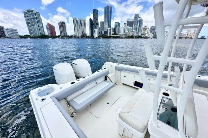 Why Knot Yacht Photos Pics 2014 Sailfish 320 CC boat with city skyline in the background.