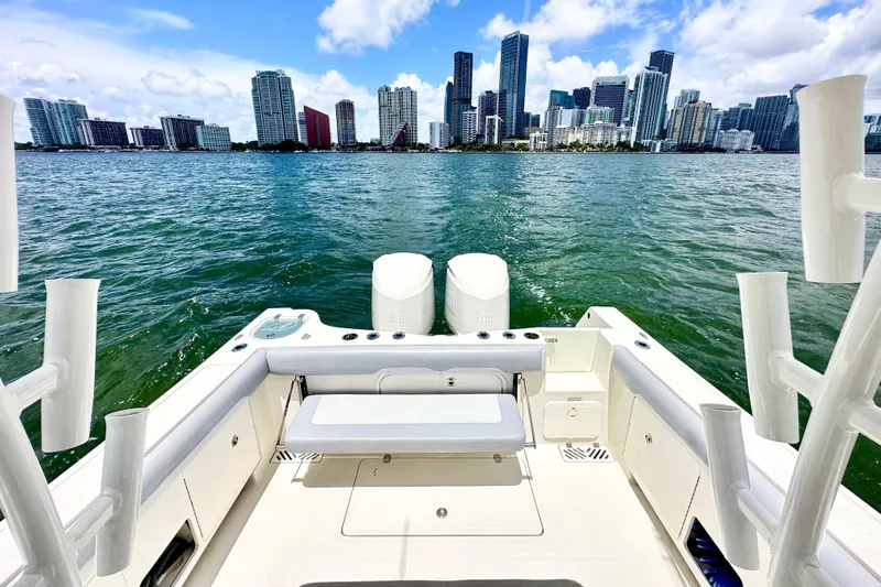 Why Knot Yacht Photos Pics 2014 Sailfish 320 CC boat with city skyline in the background.