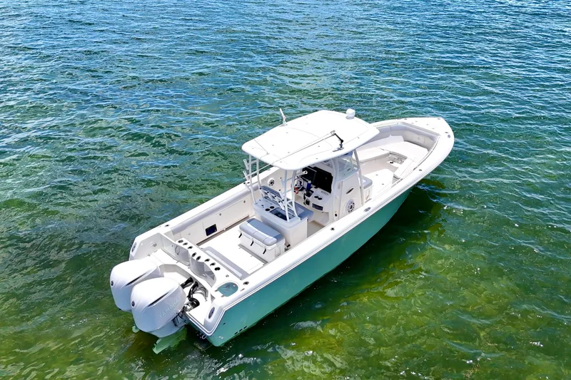 Why Knot Yacht Photos Pics 2014 Sailfish 320 CC boat on clear blue water, aerial view.