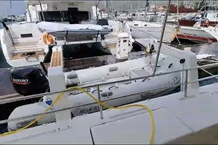 Sanouva Yacht Photos Pics 2019 Fountaine Pajot SABA 50 catamaran docked with inflatable boat and Suzuki outboard.