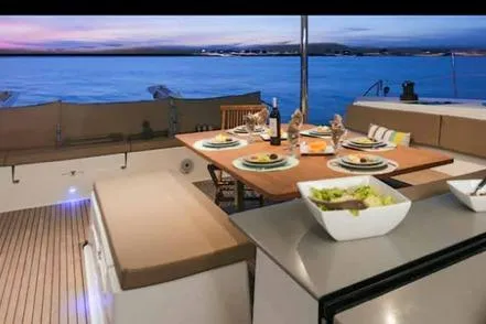 Sanouva Yacht Photos Pics Luxurious 2019 Fountaine Pajot SABA 50 yacht dining area with ocean view at sunset.
